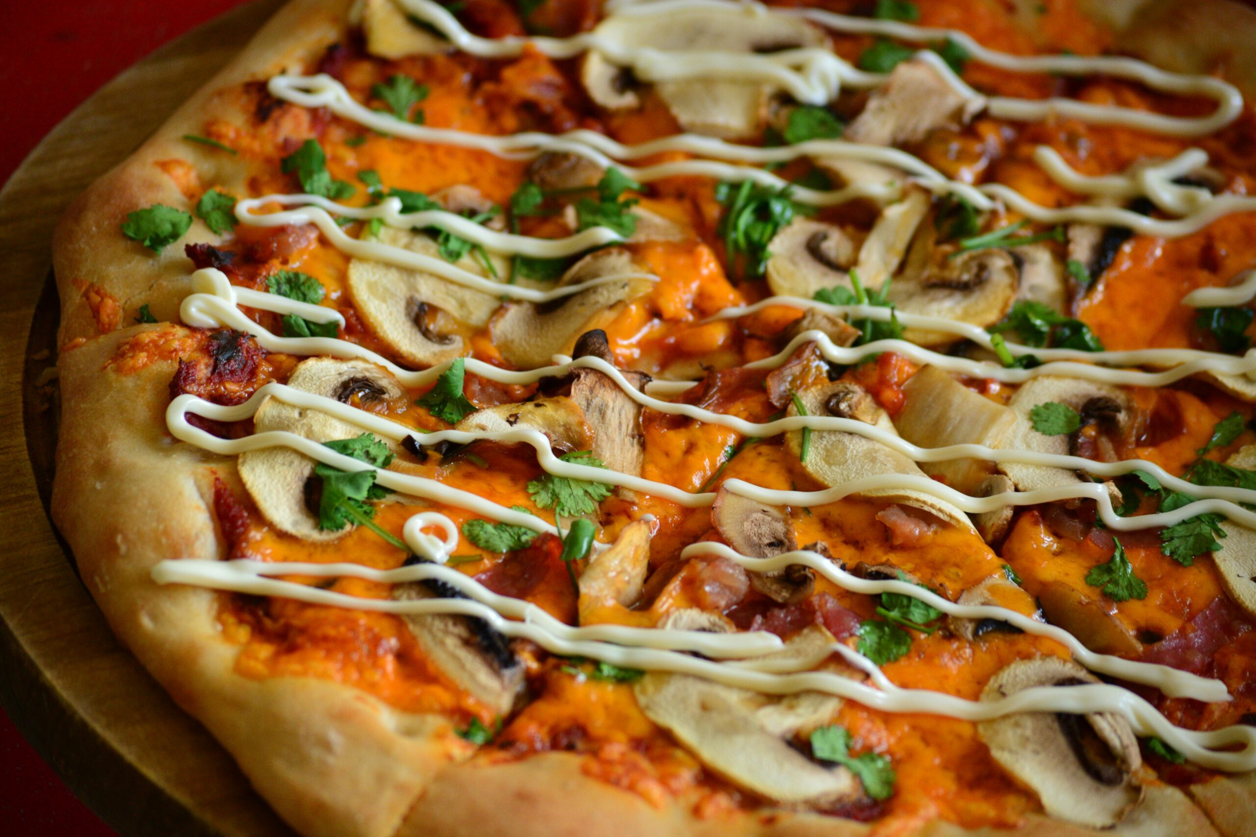 Our Menu Delicious mushroom pizza with creamy toppings and fresh herbs in close-up.